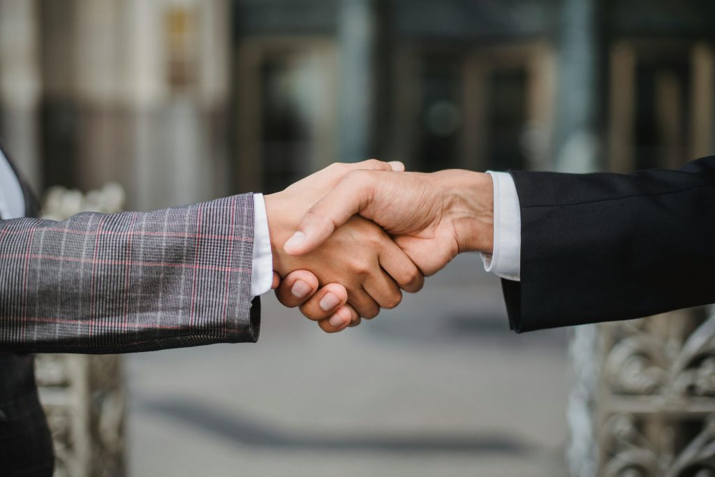 pexels photo 4963437 4963437 A close-up of two businesspeople shaking hands, symbolizing cooperation and partnership.